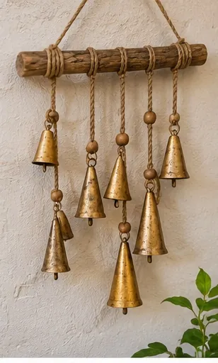Handmade bell wind chime with cone bells and wooden beads on driftwood